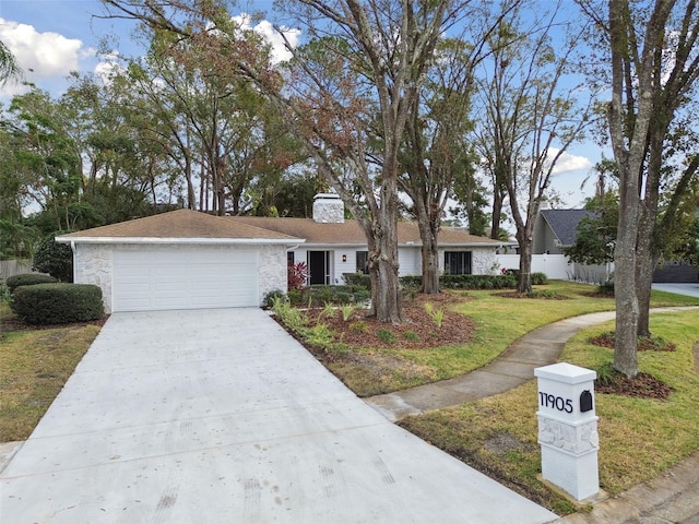 ranch-style home with a front lawn and a garage