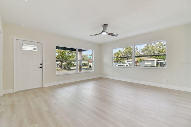 interior space featuring ceiling fan, light wood-type flooring, and plenty of natural light