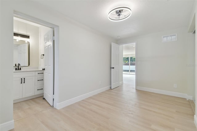 interior space featuring sink and light hardwood / wood-style flooring