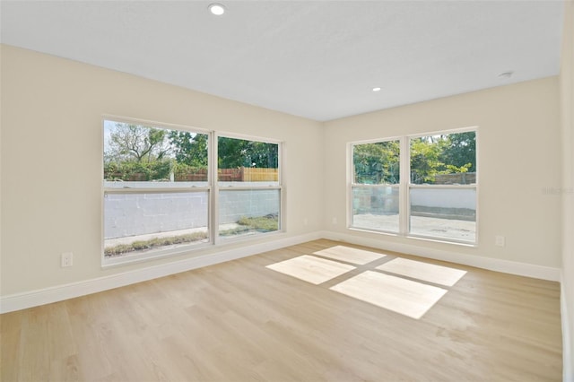 unfurnished room with light hardwood / wood-style flooring