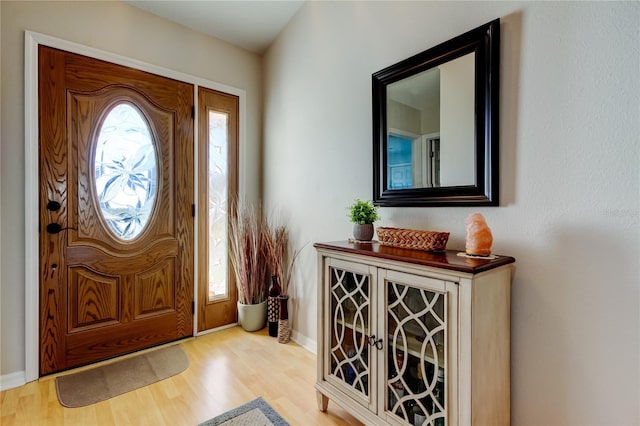 foyer entrance with light hardwood / wood-style floors