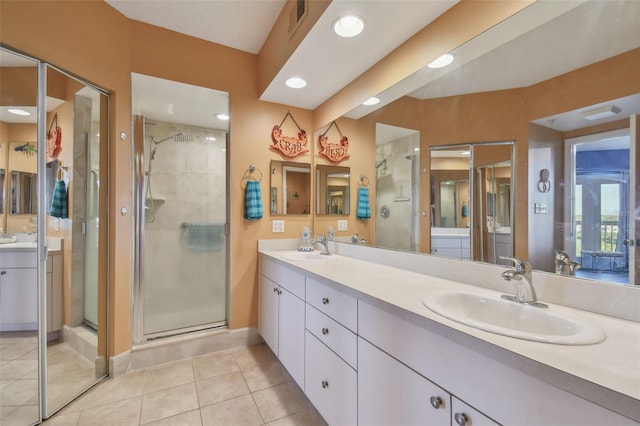 bathroom with vanity, tile patterned flooring, and a shower with door