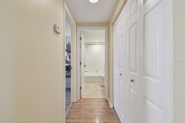 hallway with light hardwood / wood-style flooring