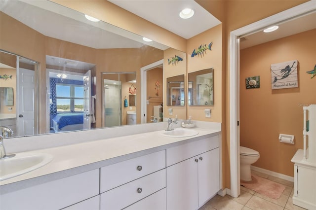 bathroom featuring toilet, vanity, and tile patterned floors