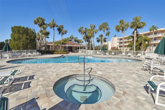 view of swimming pool with a community hot tub and a patio area