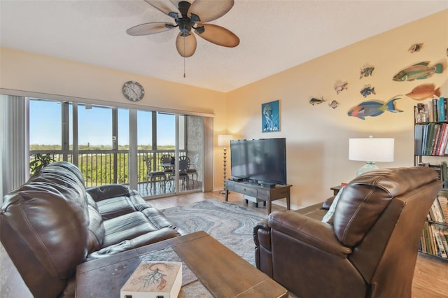 living room featuring ceiling fan and light hardwood / wood-style flooring