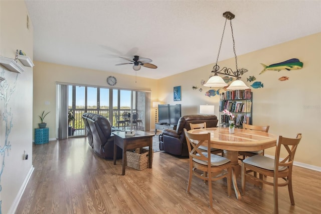 dining area featuring ceiling fan, a textured ceiling, and hardwood / wood-style flooring