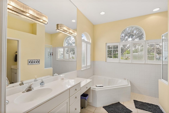 bathroom featuring tile patterned flooring, vanity, and independent shower and bath