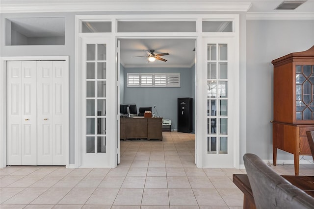 interior space with french doors, ceiling fan, ornamental molding, and light tile patterned flooring