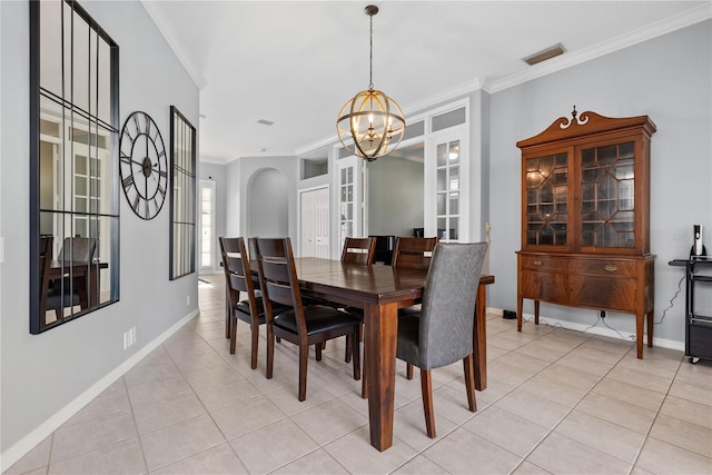 dining area featuring a chandelier, french doors, crown molding, and light tile patterned flooring