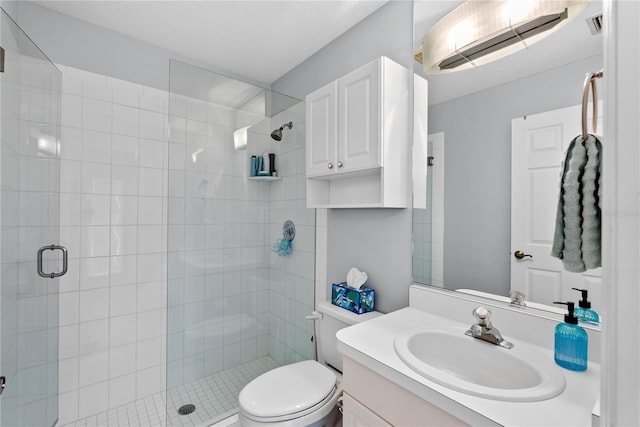 bathroom with vanity, toilet, and a shower with door