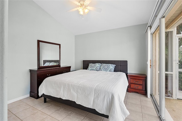 tiled bedroom with ceiling fan and lofted ceiling