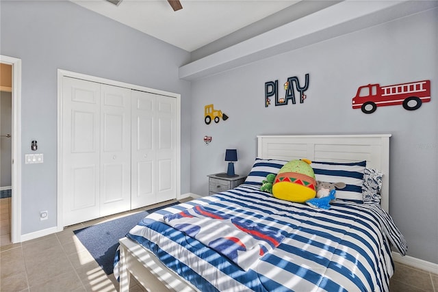 tiled bedroom featuring ceiling fan and a closet