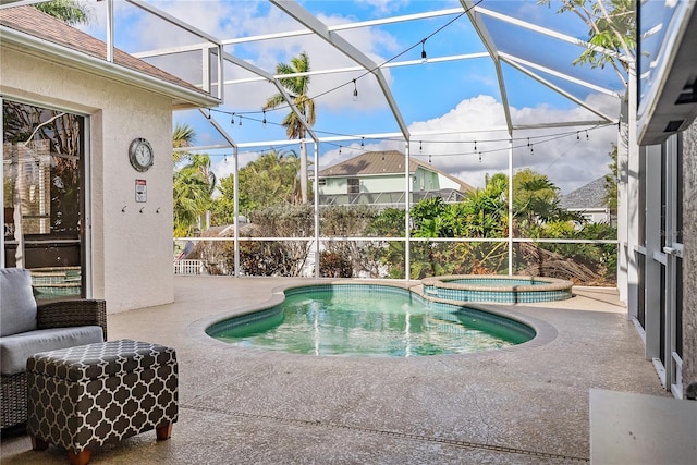 view of swimming pool featuring an in ground hot tub, a patio, and glass enclosure