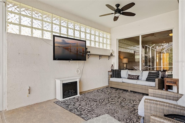 living room with carpet flooring, a wealth of natural light, and ceiling fan