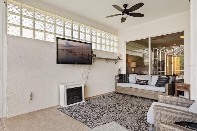 4531 Swordfish Dr, Bradenton, FL 34208 - carpeted living room featuring ceiling fan, a fireplace, and a textured wall