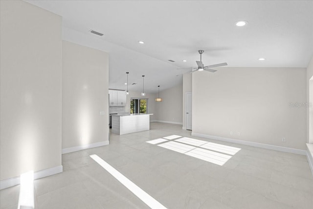 unfurnished living room with vaulted ceiling and ceiling fan