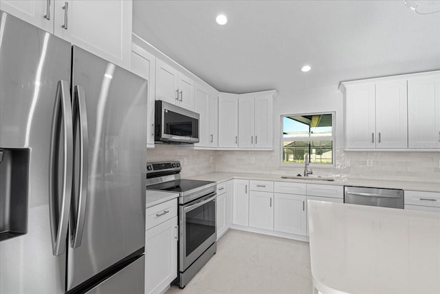 kitchen featuring white cabinets, decorative backsplash, sink, and stainless steel appliances