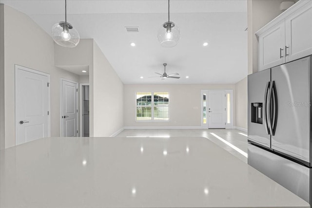 kitchen with pendant lighting, white cabinets, vaulted ceiling, ceiling fan, and stainless steel fridge with ice dispenser