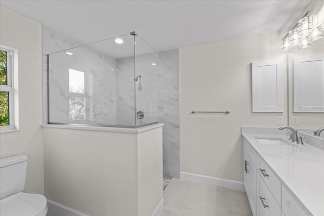 bathroom featuring a tile shower, vanity, and toilet