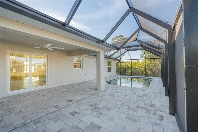 view of swimming pool with ceiling fan, a lanai, and a patio