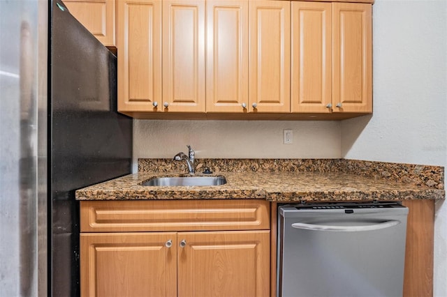 kitchen with sink, dark stone counters, and appliances with stainless steel finishes