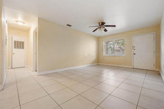 spare room with light tile patterned floors and ceiling fan