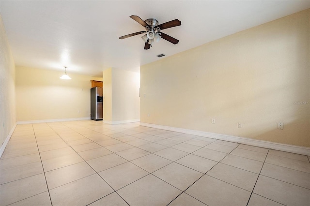 tiled empty room featuring ceiling fan