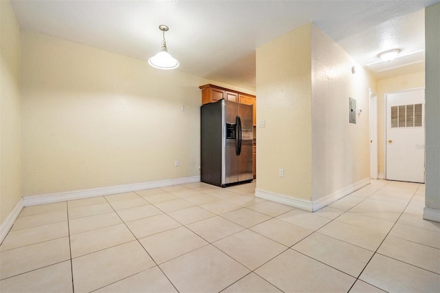 spare room with electric panel and light tile patterned flooring