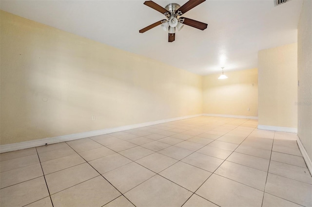 spare room featuring light tile patterned floors and ceiling fan