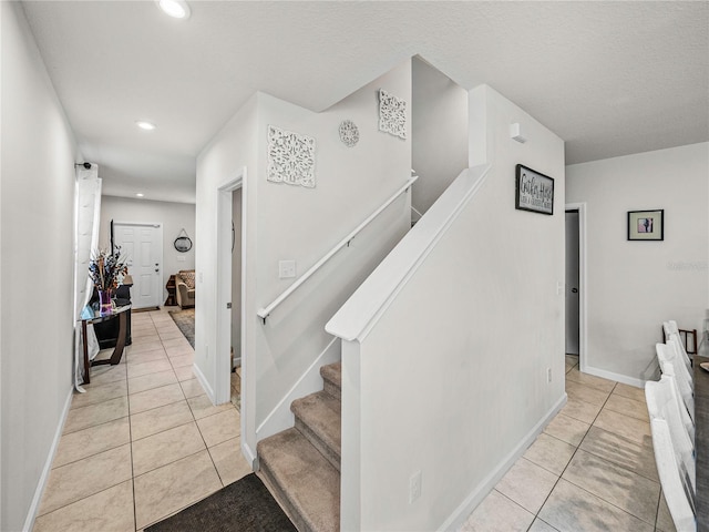 stairs featuring tile patterned flooring