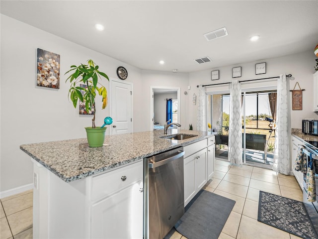 kitchen with dishwasher, sink, white cabinetry, and an island with sink