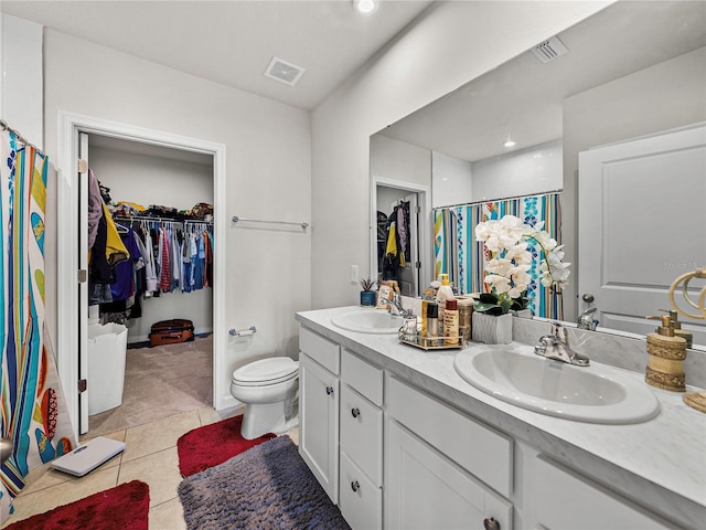 bathroom featuring walk in shower, tile patterned flooring, vanity, and toilet