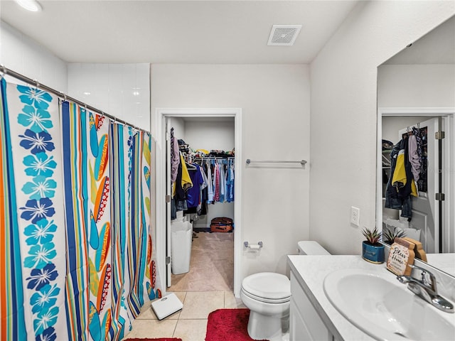 bathroom with tile patterned flooring, vanity, toilet, and curtained shower