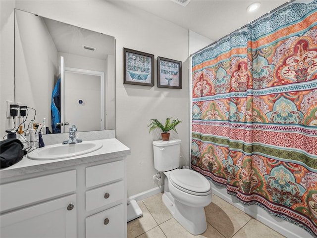 bathroom featuring tile patterned flooring, a shower with curtain, vanity, and toilet