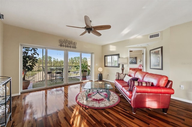 living room featuring ceiling fan and dark hardwood / wood-style flooring