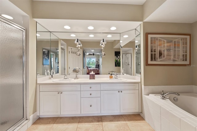 bathroom with tile patterned floors, vanity, and separate shower and tub