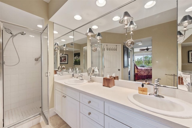 bathroom with ceiling fan, a shower with door, vanity, and tile patterned flooring