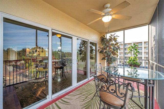 sunroom featuring ceiling fan