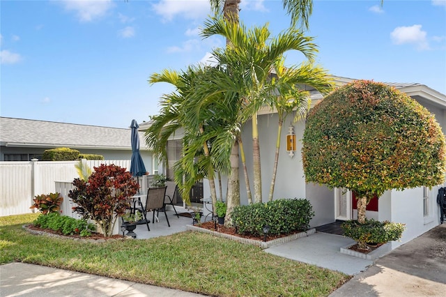 view of front of home with a front lawn and a patio area