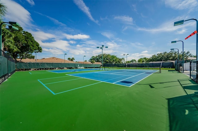 view of tennis court with basketball hoop