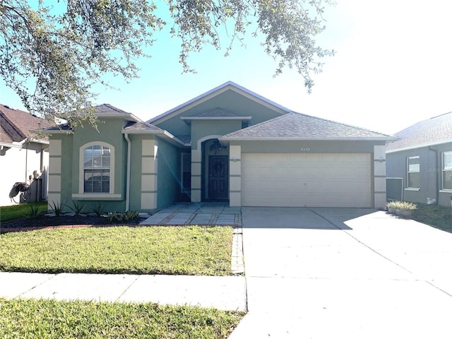 single story home with a garage and a front yard