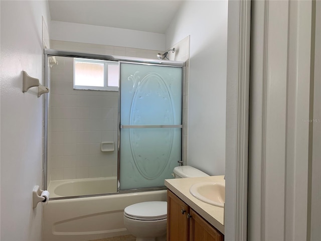 full bathroom with vanity, toilet, and bath / shower combo with glass door