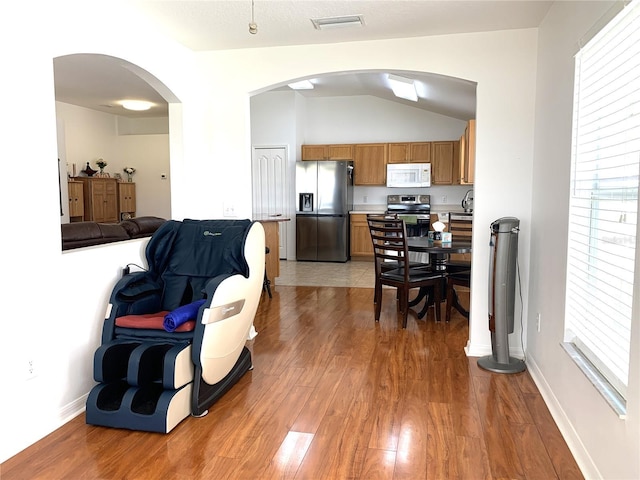 interior space with hardwood / wood-style floors and lofted ceiling