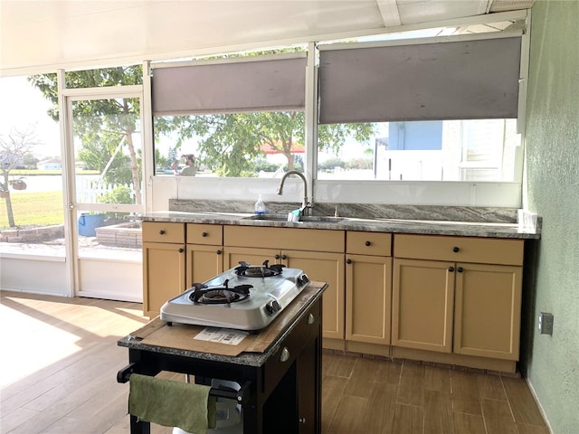 kitchen featuring hardwood / wood-style floors, cooktop, and sink