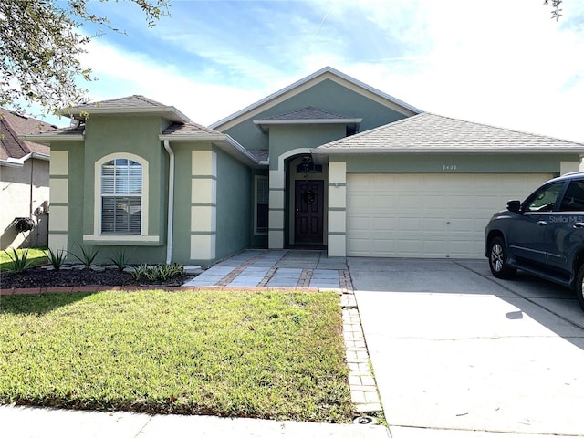 ranch-style house with a front lawn and a garage