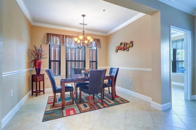 tiled dining room with a chandelier and ornamental molding