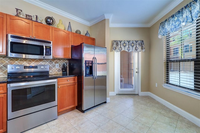 kitchen with ornamental molding, light tile patterned floors, a wealth of natural light, tasteful backsplash, and stainless steel appliances