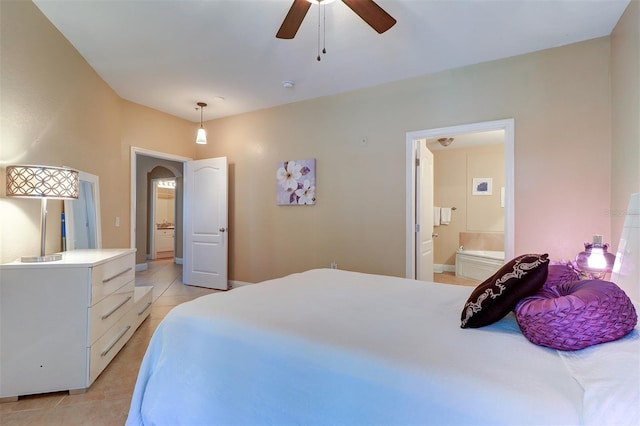 bedroom with ceiling fan, light tile patterned flooring, and ensuite bath