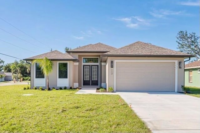 prairie-style house featuring a front yard and a garage